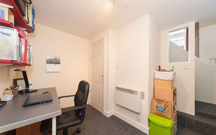 Modern residential building with balconies and greenery