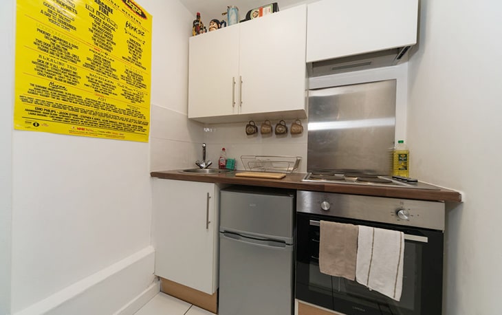 Red brick church with twin towers and trees