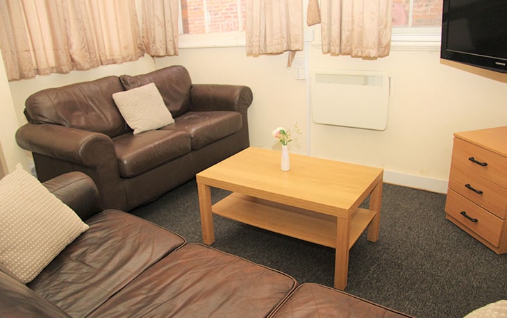 Modern stadium with curved roof and blue sky